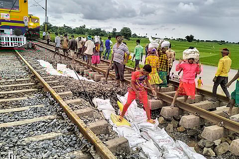 Flood in Mahabubabad: Workers restore a portion gravel under the railway track